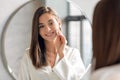 Closeup Of Beautiful Young Lady Cleansing Skin With Cotton Pad Near Mirror Royalty Free Stock Photo