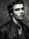Closeup of a beautiful young man in black leather jacket. Contrast black Royalty Free Stock Photo