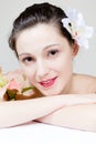 Closeup of beautiful young woman face with flower