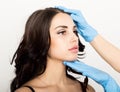Closeup of Beautiful young woman gets injection in eye and lips area from beautician. cosmetology concept Royalty Free Stock Photo