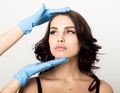Closeup of Beautiful young woman gets injection in eye and lips area from beautician. cosmetology concept Royalty Free Stock Photo