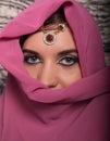 Closeup of beautiful young woman with oriental make-up and shawl over her head. caucasian woman dressed in oriental