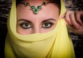 Closeup of beautiful young woman with oriental make-up and shawl over her head. caucasian woman dressed in oriental