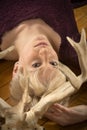 Young blonde woman lying among caribou antlers in the studio.