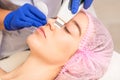 Closeup of beautiful young woman receiving ultrasound facial exfoliation and cavitation facial peeling with ultrasonic Royalty Free Stock Photo