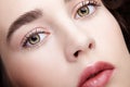 Closeup beauty macro face portrait of young woman. Brunette girl