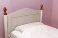 Closeup of a bed with pink linen in the bedroom