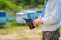 Closeup of bee smoker at beekeper s hands at apiary.