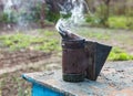 Closeup of beekeeper smoker on old beehive