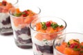 Beet and salmon appetizers in little glasses on white background