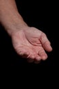 Closeup of a begging hand gesture on a black background