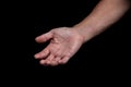 Closeup of a begging hand gesture on a black background