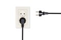 Beige double electrical outlet and two wires with plugs Royalty Free Stock Photo