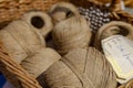 Closeup of beige linen yarns in a basket at a flea market in Paris, France