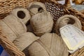 Closeup of beige linen yarns in a basket at a flea market in Paris, France