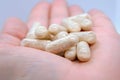 Closeup of a beige pills in one hand. Medicine pills