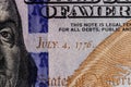 Closeup of Ben Franklin and the date of independence July 4, 1776 on a one hundred dollar bill for background VI