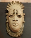 Closeup of a Benin ivory mask, featuring intricate designs and carvings