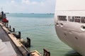 Closeup of berthed cruise ship tied to pier with rope Royalty Free Stock Photo