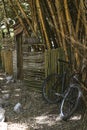 Closeup of a bicycle leaning against the bamboo fence