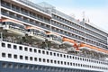 Closeup of a big cruise liner and its rescue boats.