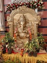 Closeup of Big Golden Color Lord Ganesha Statue at the entrance of Hindu Wedding Hall or Kalyana Mantapa during Marriage