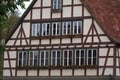 Closeup of a big house with windows and potted flowers on windowsills in the countryside