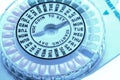 Closeup of birth control pill dispenser showing days of the week