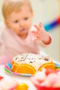 Closeup on birthday cake and eat smeared baby