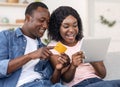 Closeup of black couple making purchases online, holding digital tablet Royalty Free Stock Photo