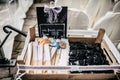 Closeup of black glasses and straw fans in a box near chairs, a black wedding board near