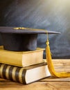 Graduation Hat Above a Stack of Books on a Wooden Desk - Generative Ai Royalty Free Stock Photo