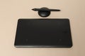 Closeup of black graphics tablet on the bright desk.Designer workplace