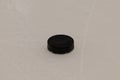 Closeup of black hokkey washer on ground Royalty Free Stock Photo