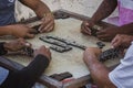 Closeup of black Latinos hands playing dominoes in the neighborhood of La Marina Matanzas, Cuba