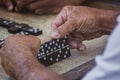 Closeup of black Latinos hands playing dominoes in the neighborhood of La Marina Matanzas, Cuba