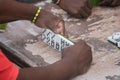 Closeup of black Latinos hands playing dominoes in the neighborhood of La Marina Matanzas, Cuba