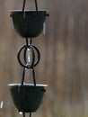 Closeup of a Black Metal Rain Chain While it`s Raining