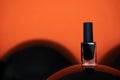 closeup black nail polish on balloon orange background