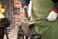 Closeup of a blacksmith working with a hammer