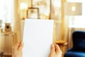 Closeup on blank paper sheet in hand of modern housewife