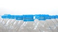 Closeup of blue cap of a group of transparent plastic empty bottles