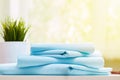 Closeup of blue clean bedding on a blurred background. A stack of folded new bed sheets on the table. Royalty Free Stock Photo