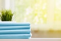 Closeup of blue clean bedding on a blurred background. A stack of folded new bed sheets on the table. Royalty Free Stock Photo