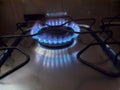 Closeup Blue Fire Flame From Top Of Home Kitchen Stove. Gas stove with burning propane gas flames. Royalty Free Stock Photo