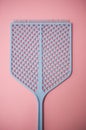 Blue fly swatter on pink background Royalty Free Stock Photo