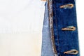 Closeup of blue jeans fabric with pocket. Wrong side