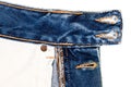 Closeup of blue jeans fabric with pocket. Wrong side