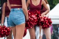 blue jeans short of pompom girls waiting before show at Fun car show event Royalty Free Stock Photo