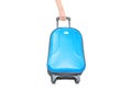 Closeup blue luggage with blurred woman hand dragging a luggage isolated on white background , fabric luggage with plastic roller Royalty Free Stock Photo